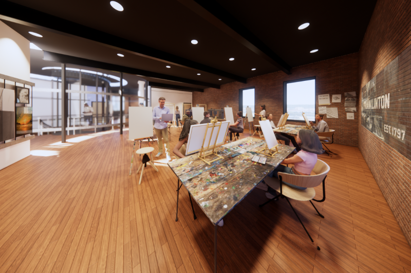 This photo is a rendering of the open studio space. This studio is on the second floor of the building, and on the left side of the image, behind the artwork displayed on the cable system, you can see the spiral space the the main stairs and circular elevator are enclosed within and the spiral skylight above them. Throughout this space there are tables and workstations that have canvases and paper for painting and drawing, sewing machines to sew and embroider, and large looms to weave.