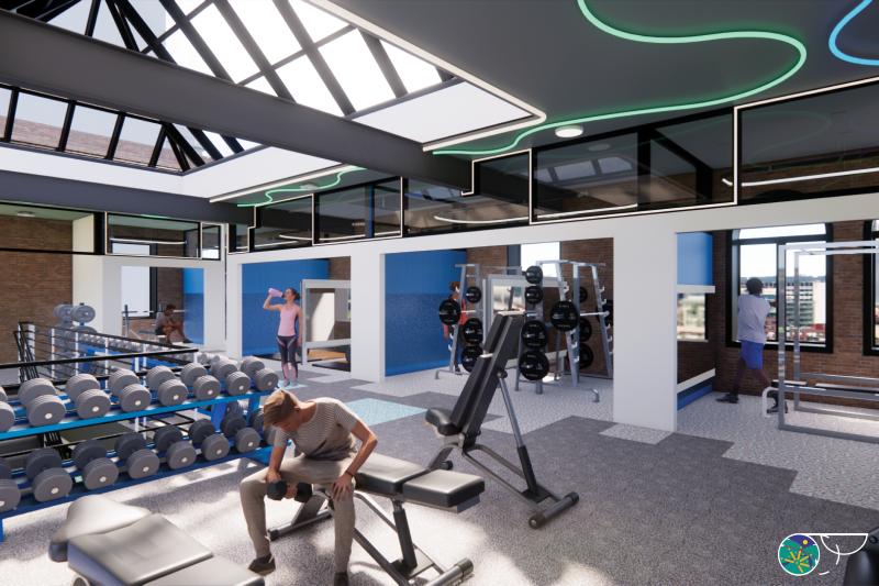 Large open gym with a skylight above and tiny built-in rooms that support different lifting functions. Weight machines and dumbbells surround the space and support the user. 