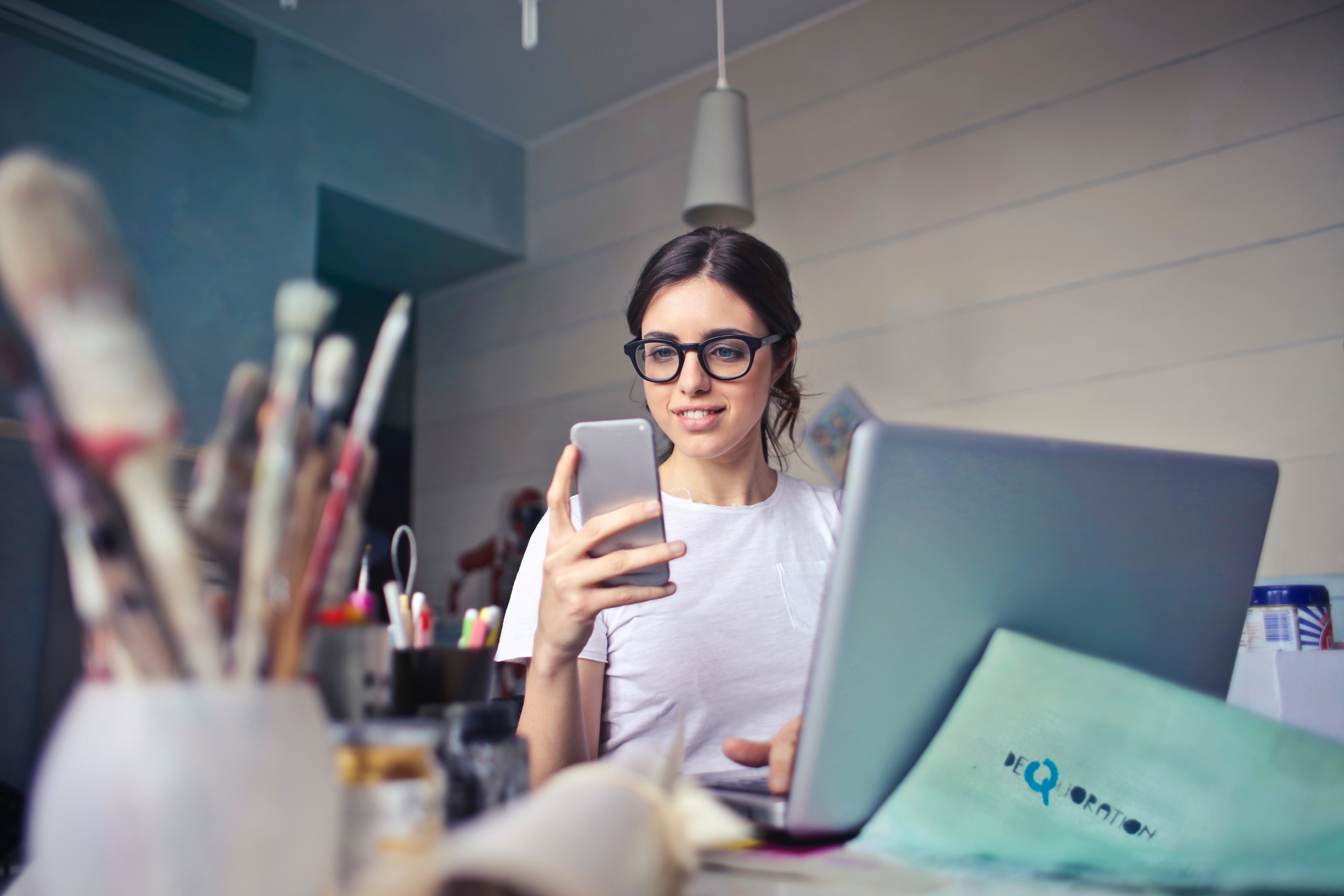 woman in white shirt using smartphone. Photo by Bruce Mars on Unsplash.