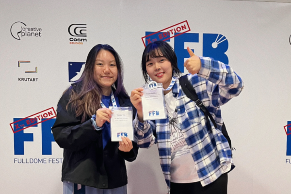 Valeska and Yeoleum smile with badges.
