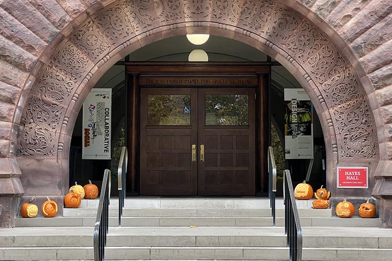 Photo of carved pumpkins on the front steps of Hayes Hall.