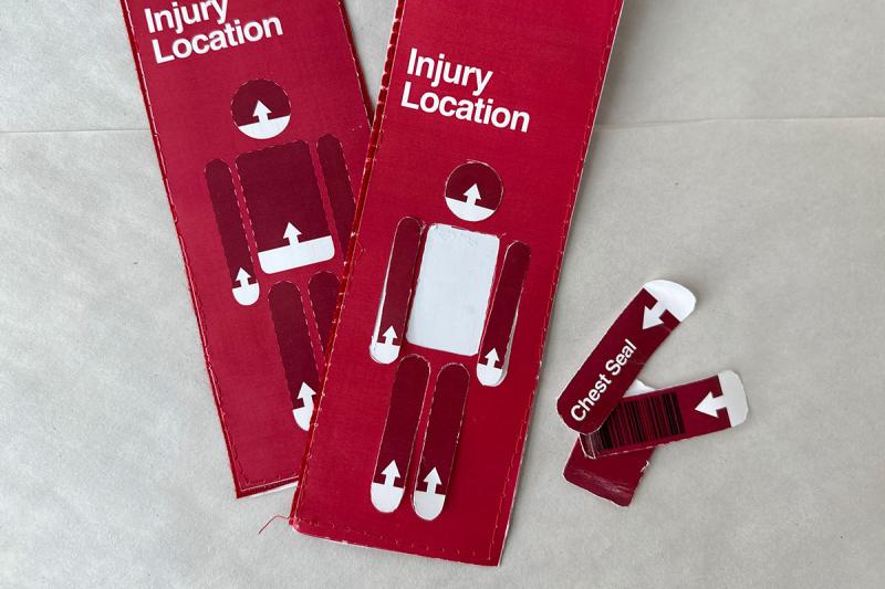 Two red tags that pictures a clip art style person labeled with “injury location