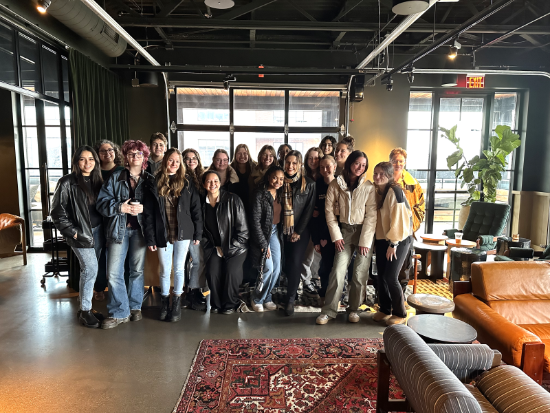 Students gathered in the event space of The Junto’s rooftop bar Brass Eye.