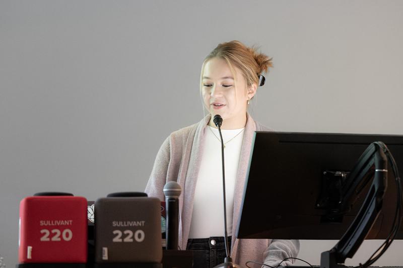 Sarah Kocher speaking at a lectern