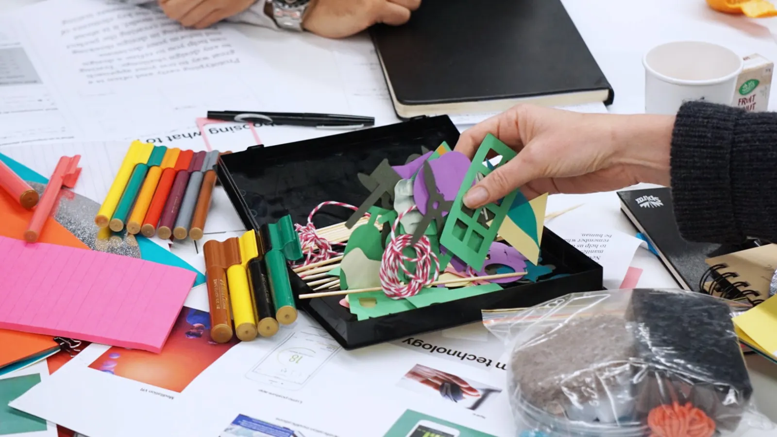 person holding paper cutout decors - Photo by Jo Szczepanska on Unsplash