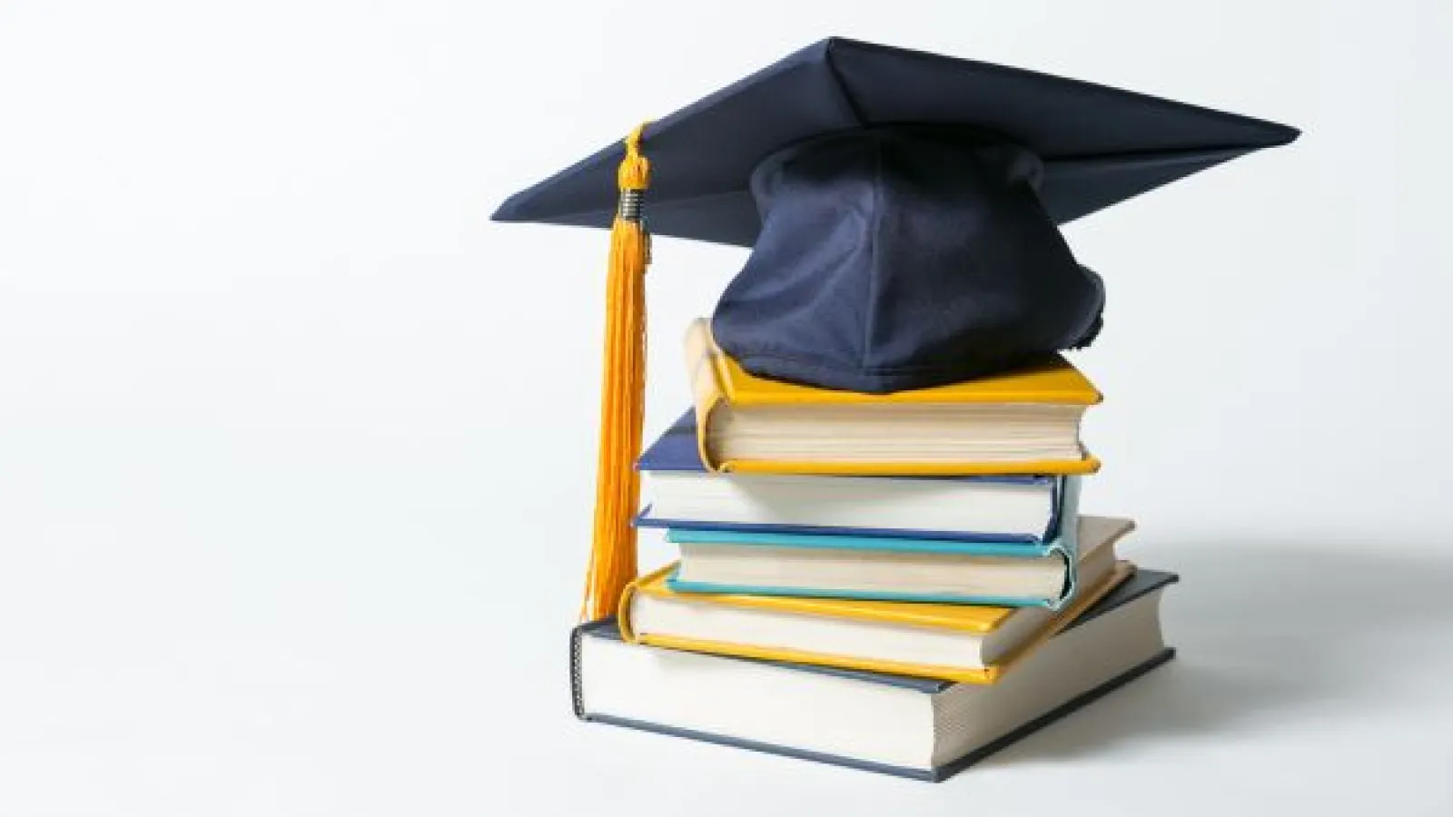 graduation cap and academic books