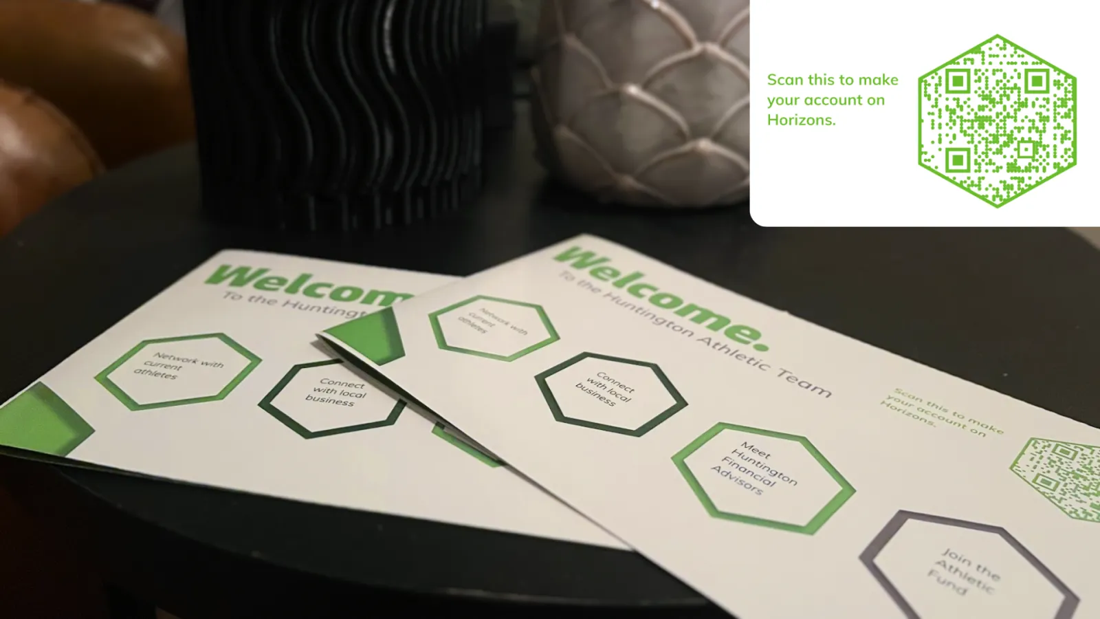 2.	Pamphlets on a tabletop displaying the various points of interest for a student athlete to join the Horizons program. In the corner is displayed a QR code which will direct you to the application. 