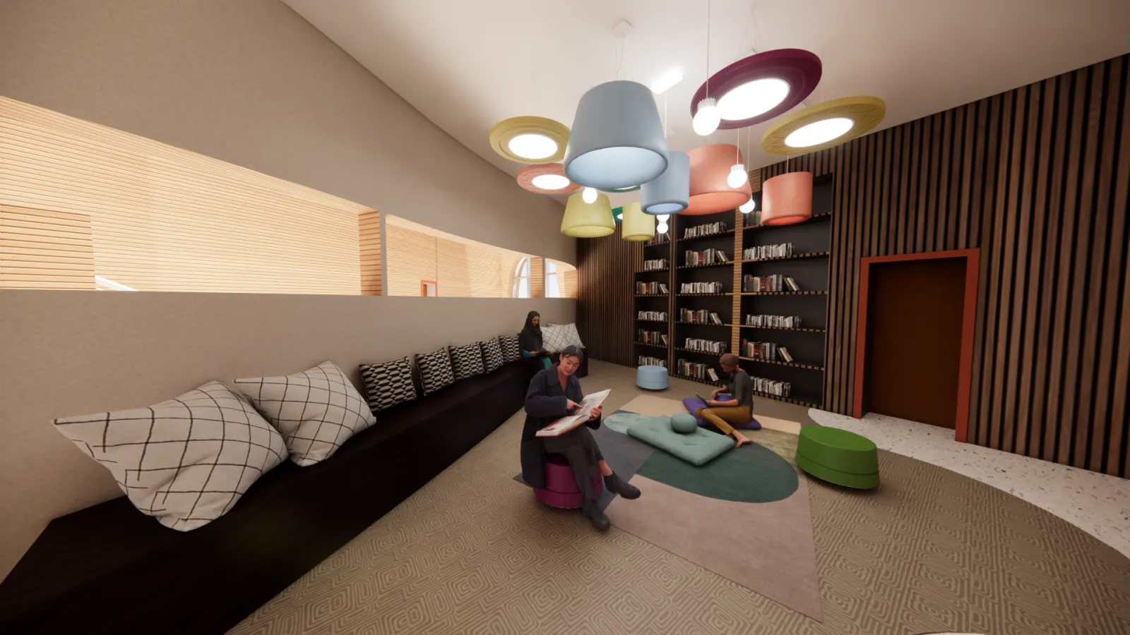 A cozy reading nook in a modern library featuring a curved built-in bench with decorative pillows, a bookshelf filled with books, and a soft seating area with floor cushions and stools. The space is illuminated by large, colorful pendant lights hanging from the ceiling. A woman sits on a stool reading a book, while another person lounges on the floor with a book. A third individual is seated on the bench, engaged in reading. The walls combine wood paneling and neutral tones, with a horizontal window prov