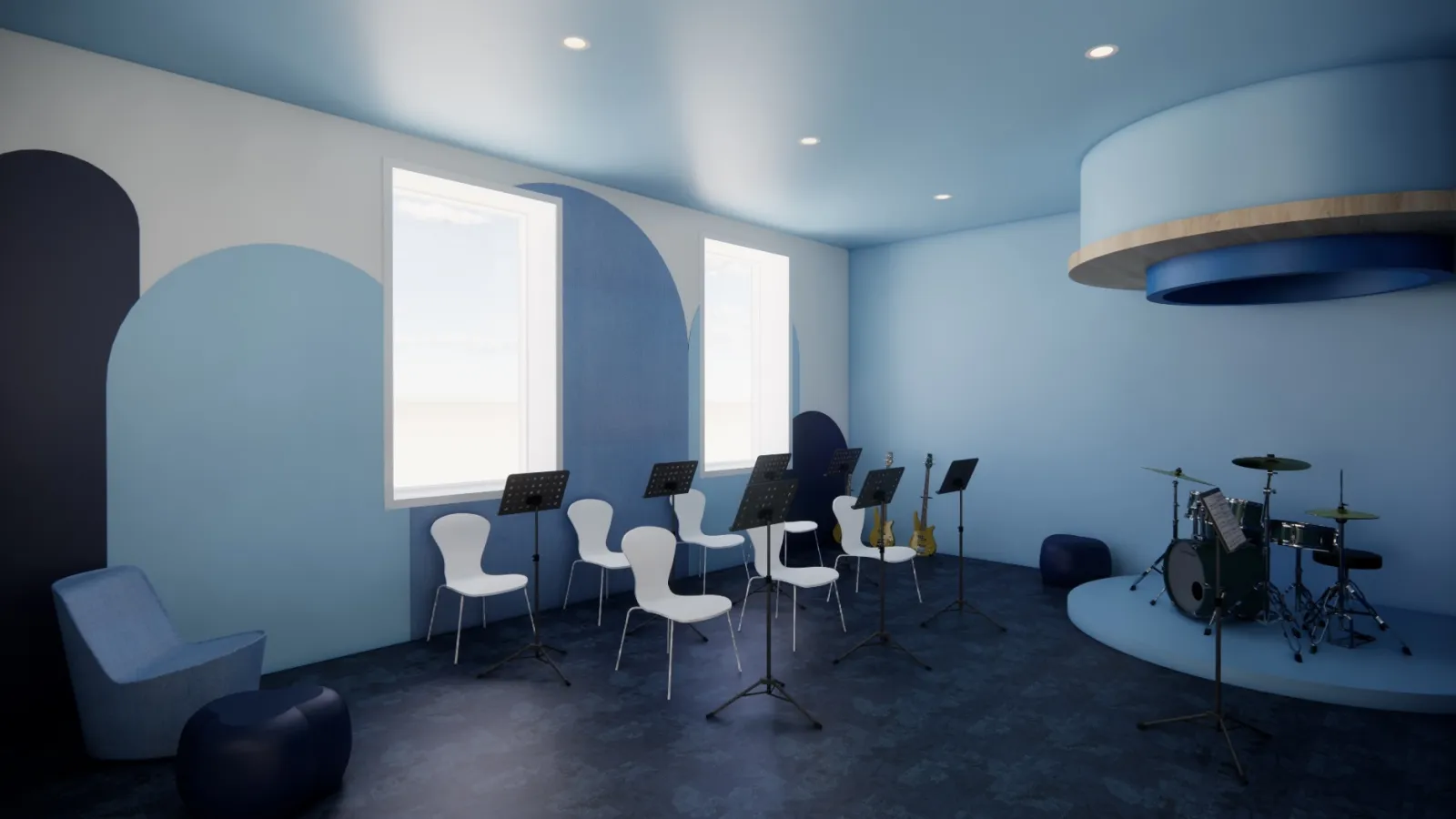 The music room is a calm, blue-toned space equipped with instruments and seating for group music activities. The design promotes focus and collaboration in a creative setting.