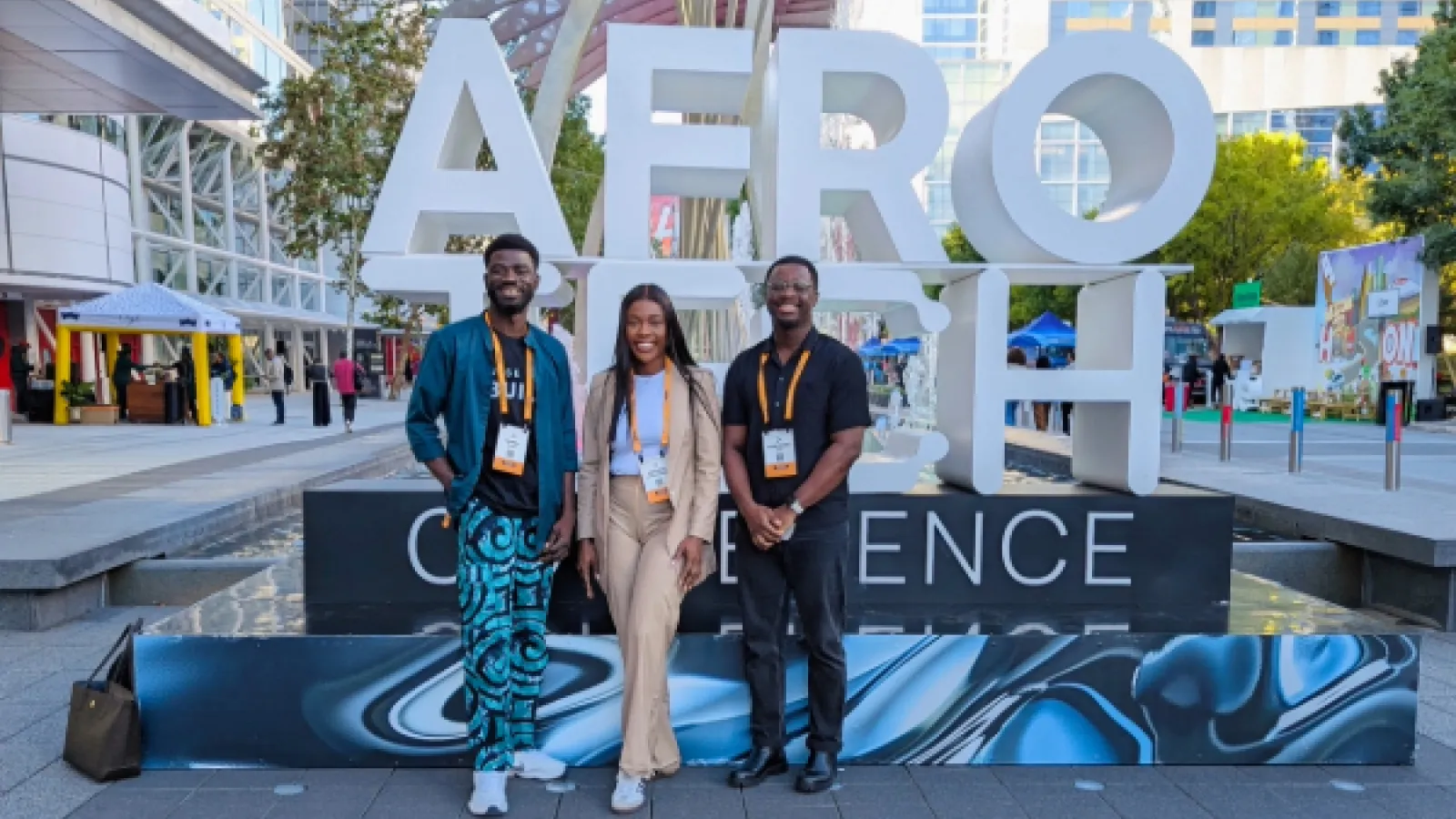 Students stand infront of AfroTech Conference sign