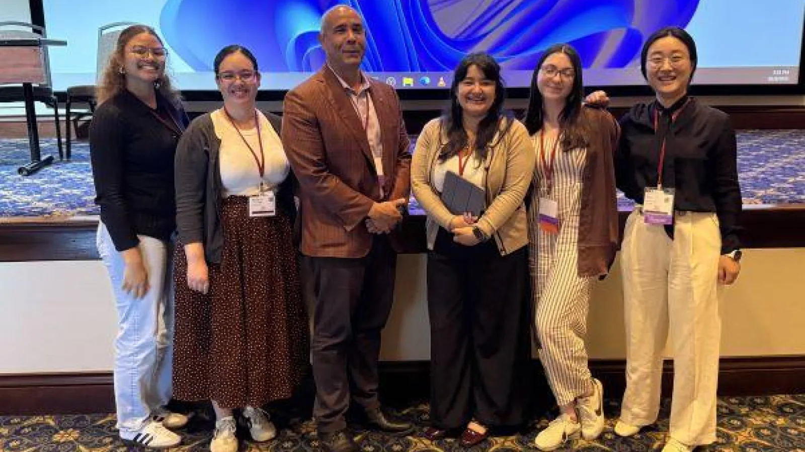 the graduate assistants and Maurice Stevens after a conference presentation