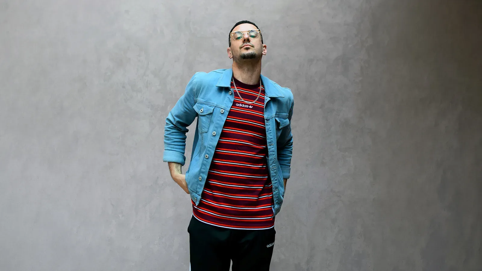 a man standing in front of a grey background 