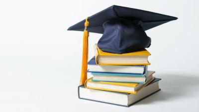 textbooks with graduation cap