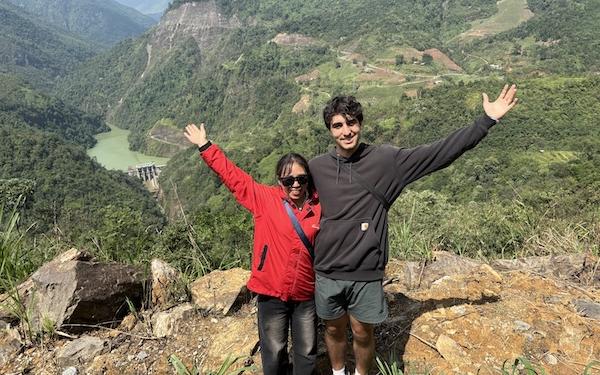 Phillip Biondo with a friend in front of a mountain vista.