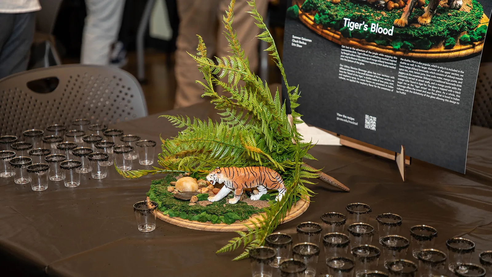 Small glasses arranged around a mocktail centerpiece.