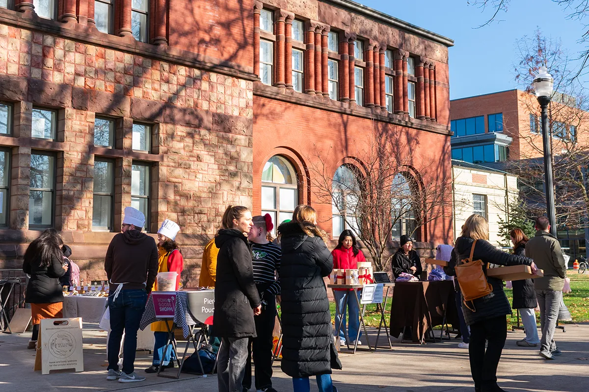 People walking around market display tables in front of Hayes Hall on Ohio State’s Columbus campus.