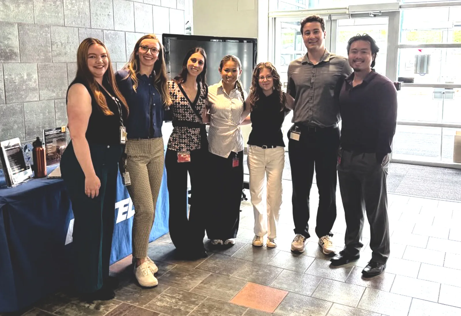 Students posing for a photo in the lobby of Battelle headquarters.