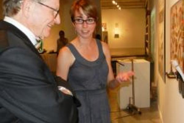Two people admiring artwork