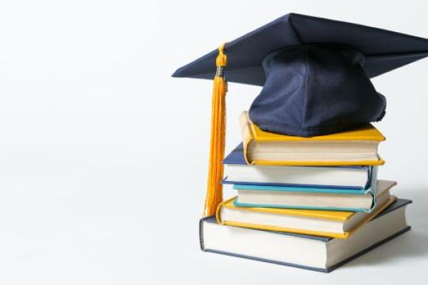 graduation cap and academic books