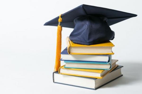 graduation cap and academic books