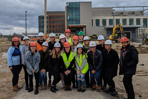 Students pose in front of Wexner Medical Center Outpatient Care Dublin construction site. 