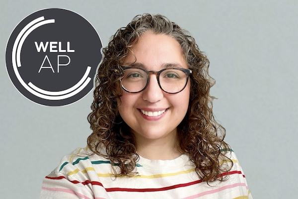 Emily in front of WELL AP badge