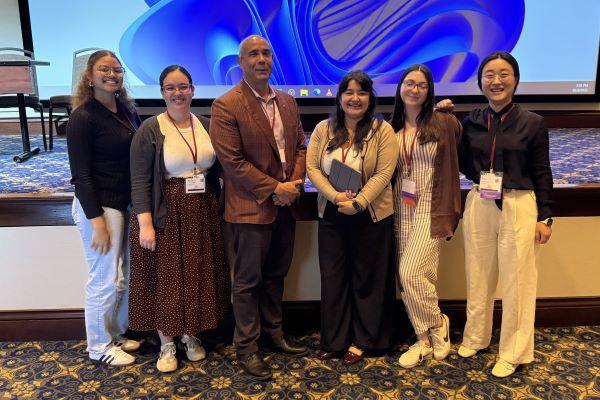 the graduate assistants and Maurice Stevens after a conference presentation
