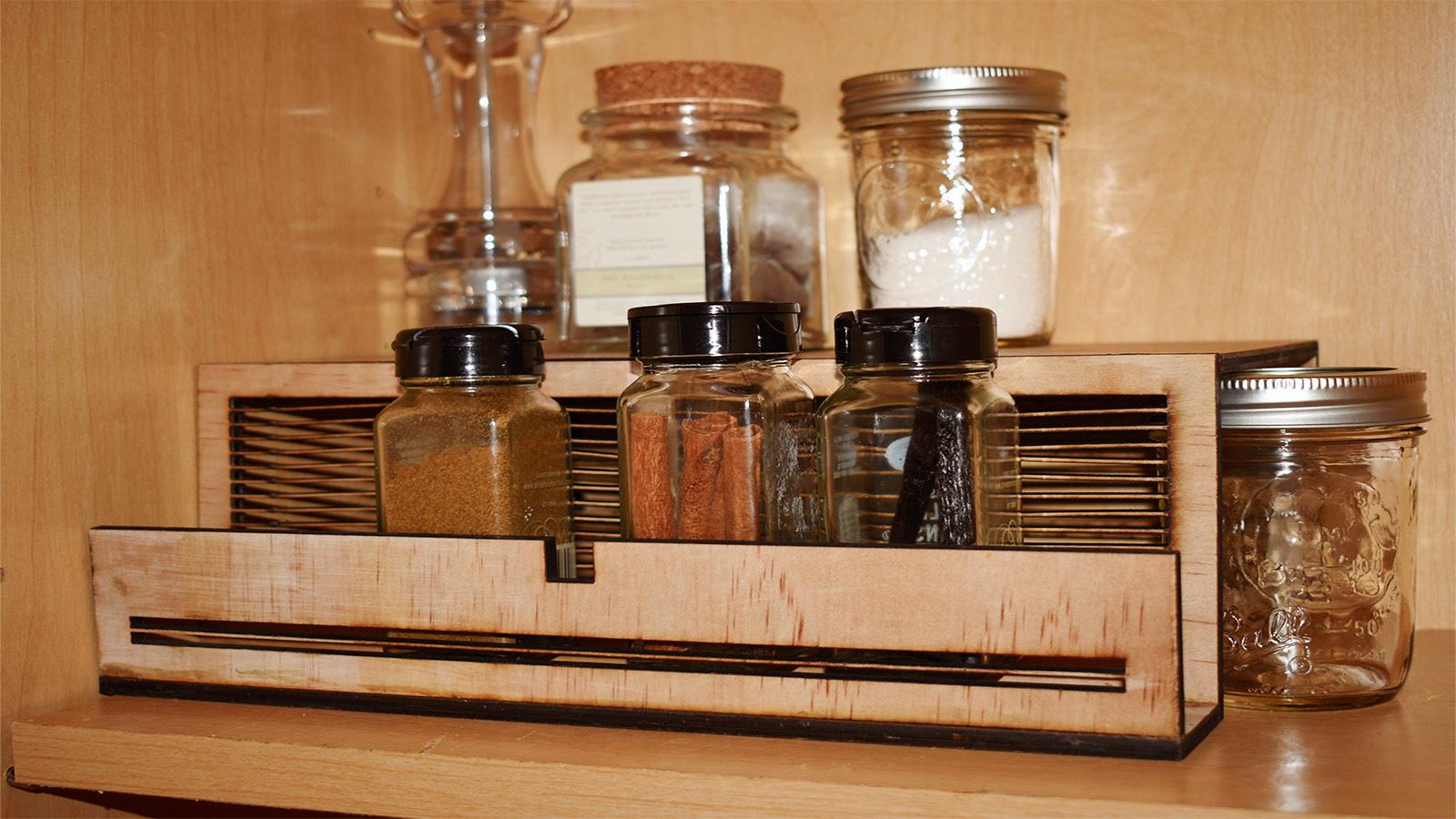 hhandcrafted shelf organizer shown with jars on it in a cabinet