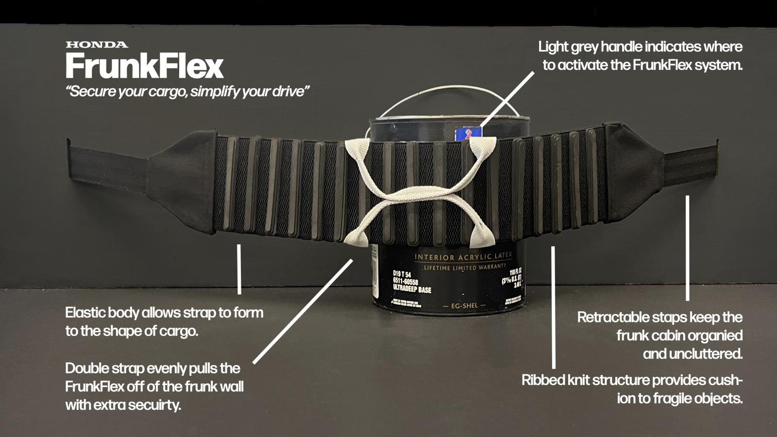 A product prototype labeled "FrunkFlex" is displayed against a black background. The device is a flexible cargo-securing strap with ribbed knit padding, stretched around a paint can to demonstrate its functionality. White text annotations highlight key features, including an elastic body that conforms to cargo, a retractable strap system for organization, and a double strap for extra security. The light gray handle marks the activation point for the system.