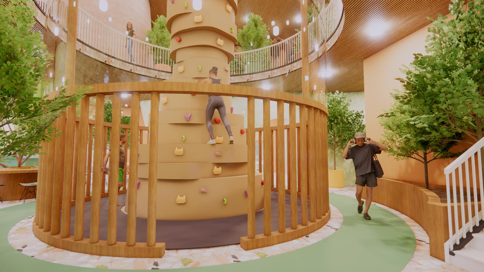 Aspaciousindoorclimbingareafeaturingacylindrical,nature-inspiredclimbing wall with colorful handholds. A woman is actively climbing while others walk along a curved pathway lined with lush green trees. A second-floor balcony with a white railing overlooks the space, adding depth and openness to the environment.