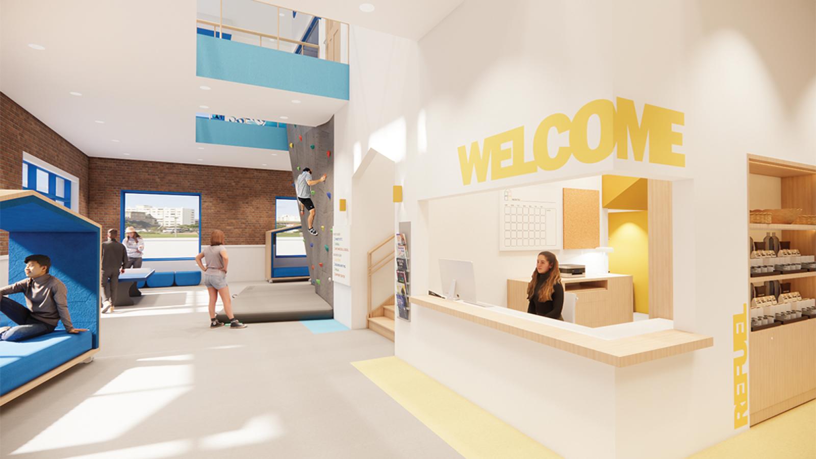 A perspective view of the reception area with a person sitting at the desk, which has “WELCOME” in yellow above with the staircase beside it. In the back is the kinesthetic learning area, featuring a rock-climbing wall with a mat below, where a boy is climbing, and a girl is watching. Nearby, two people play ping pong, while a boy sits on a blue modular portable bench.