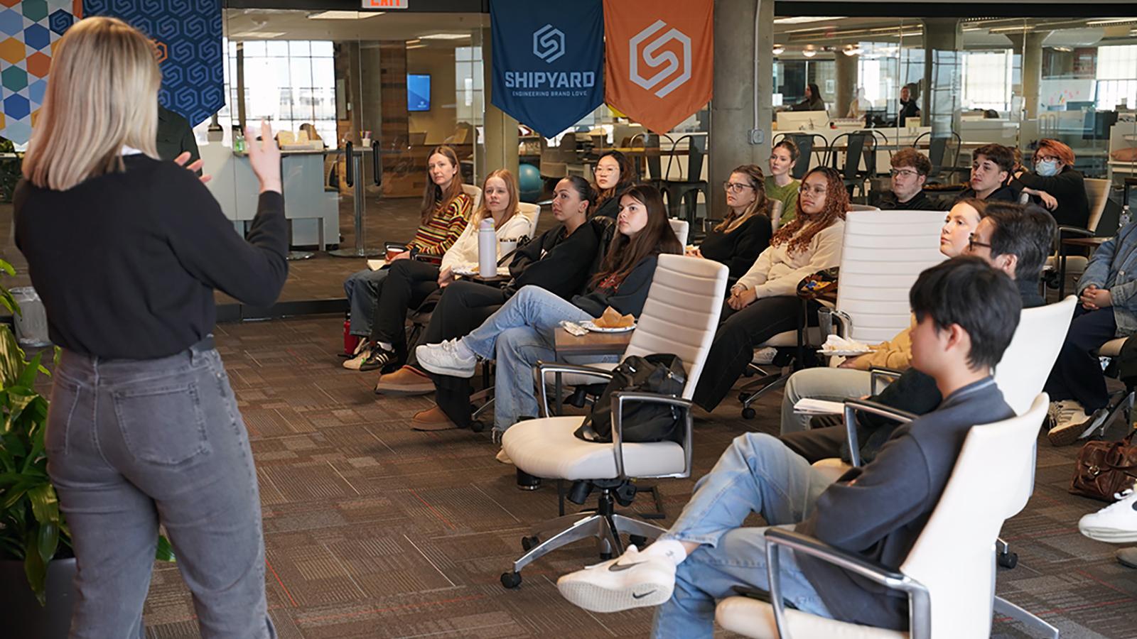 Students listening to professional presentation