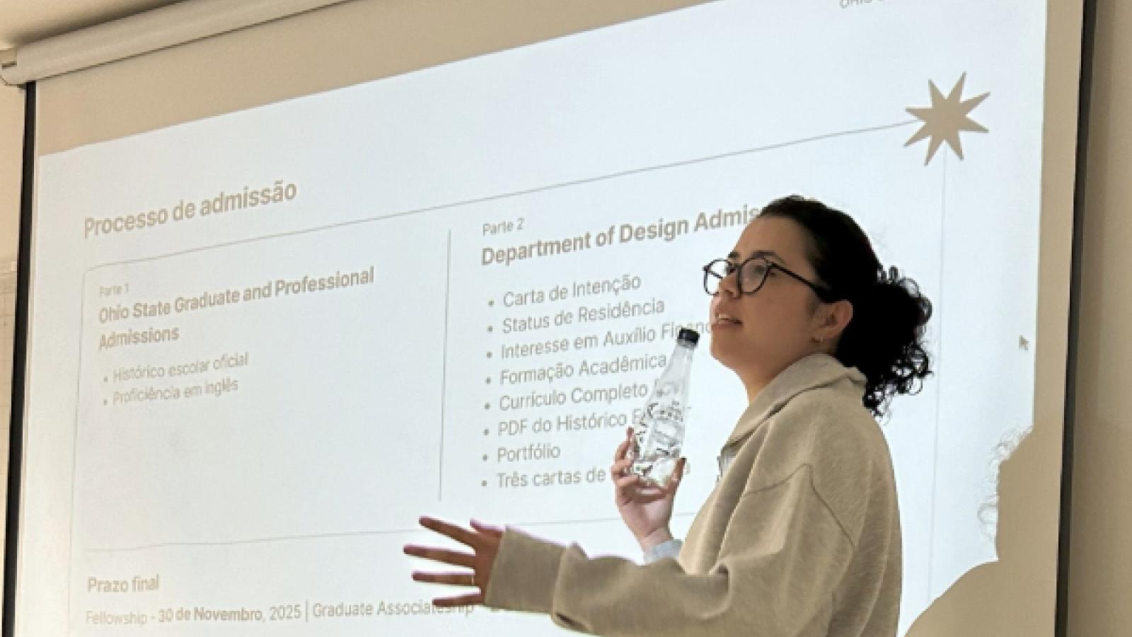 Barbara speaks in front of a screen